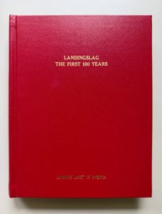 Gold print on a red book with no other adornments. The title is Landingslag, the First 100 Years. The only other print is at the bottom: Landings Laget of America.