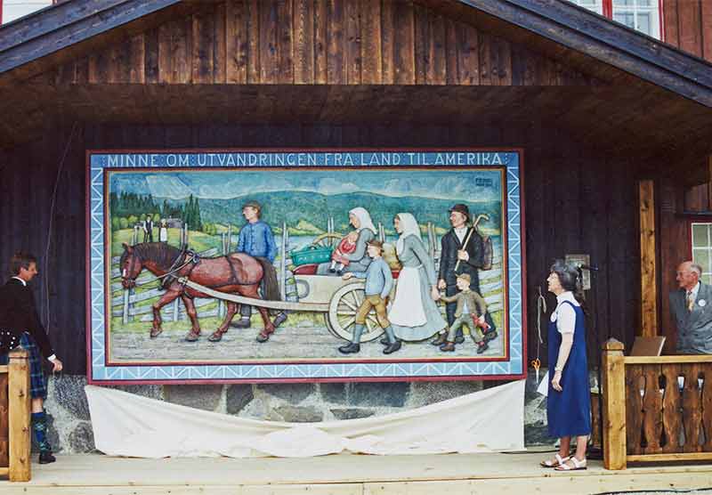 Alastair Brown and Ann Edwards unveiling the Emigrant Relief at the Lands Museum with Per Einbu looking on.
